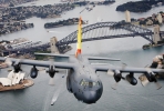 A C-130H Hercules A97-005 flies over Sydney Harbour. Image courtesy of Department of Defence.