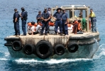 An Australian Customs boat with asylum seekers off Christmas Island. Photo by DIAC on flickr.