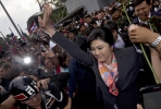 Ousted Thailand Prime Minister Yingluck Shinawatra surrounded by supporters outside the Constitutional Court. Photo by AFP.