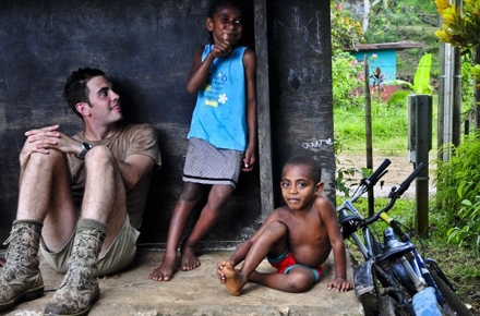 Australian sapper Jonathan Buttery sits with ni-Vanuatu children. Photo by Department of Defence on flickr.