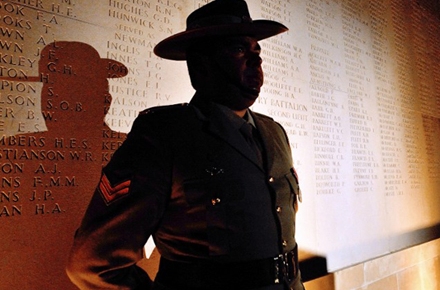 An Australian soldier stands in front of a wall bearing the names of soldiers killed in World War 1 during a dawn service at the Australian War Memorial in the northern French city of Villers-Bretonneux. Photo by AFP.  