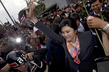 Ousted Thailand Prime Minister Yingluck Shinawatra surrounded by supporters outside the Constitutional Court. Photo by AFP.